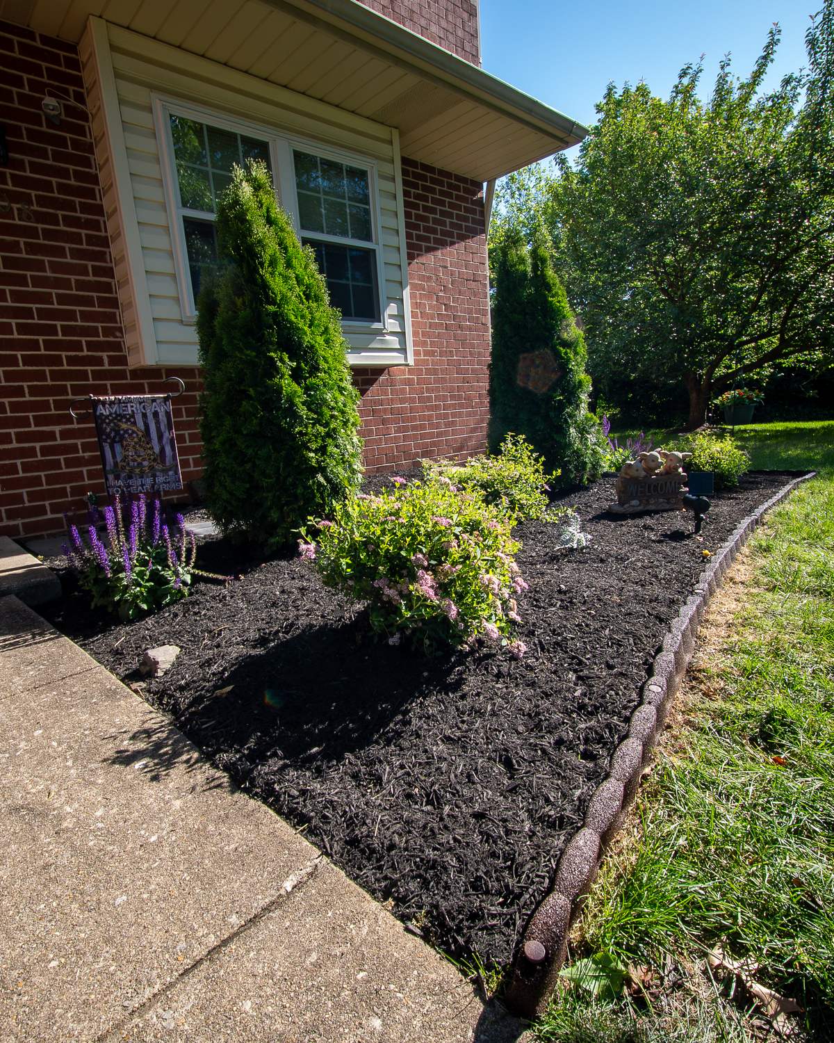 Fresh mulch and shrubs along a home