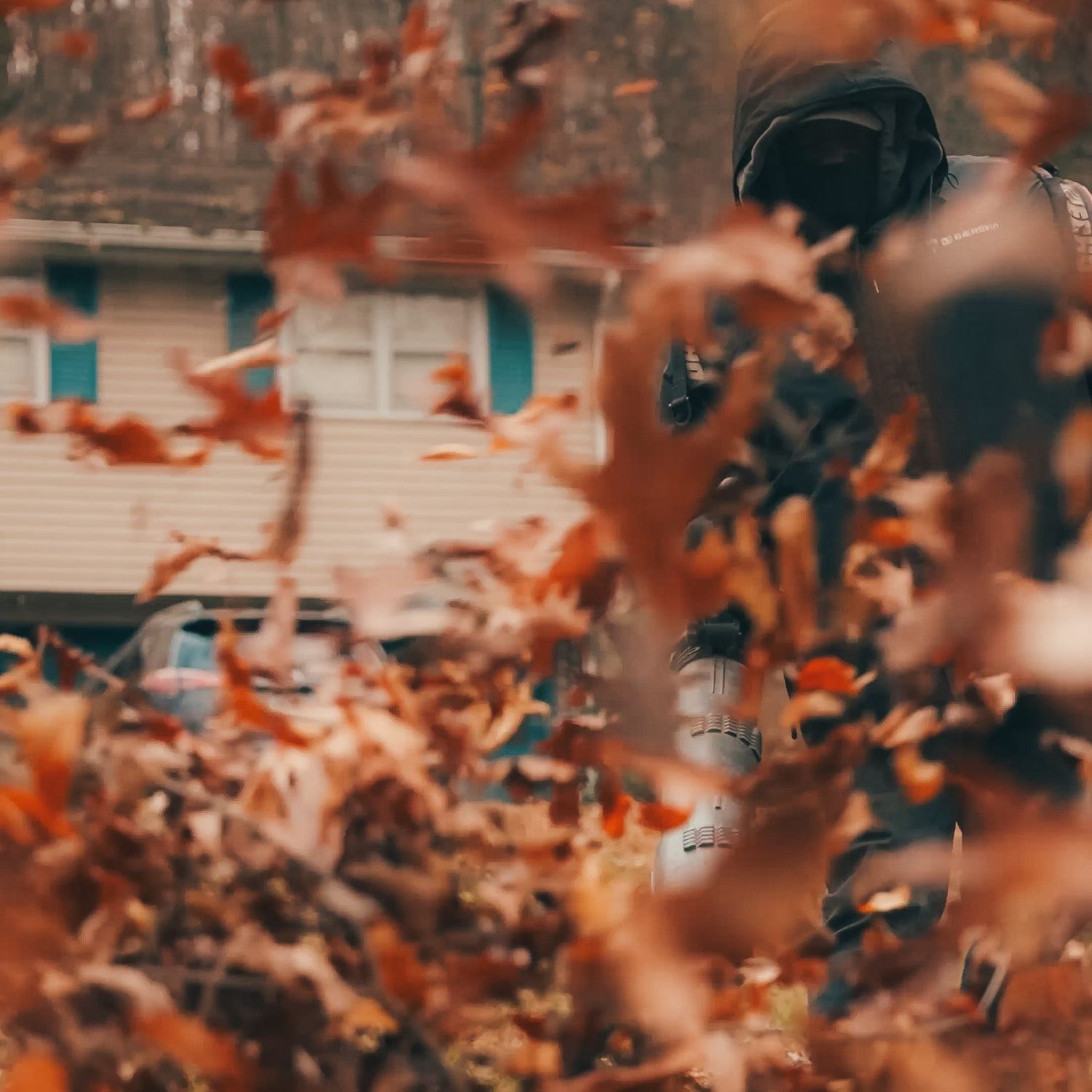 Leaves blowing as the crew clears a yard in fall