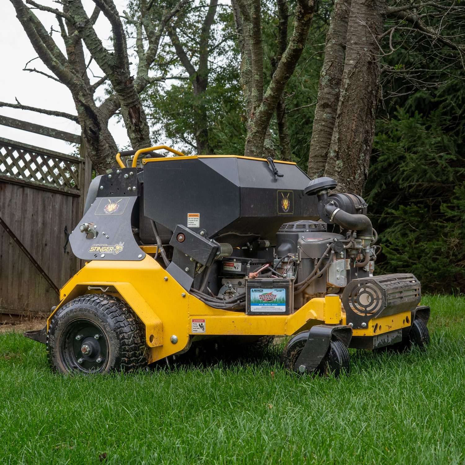 Stand-on aeration machine on a lawn